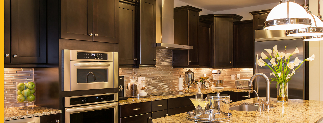 dark brown kitchen cabinets with brass accents